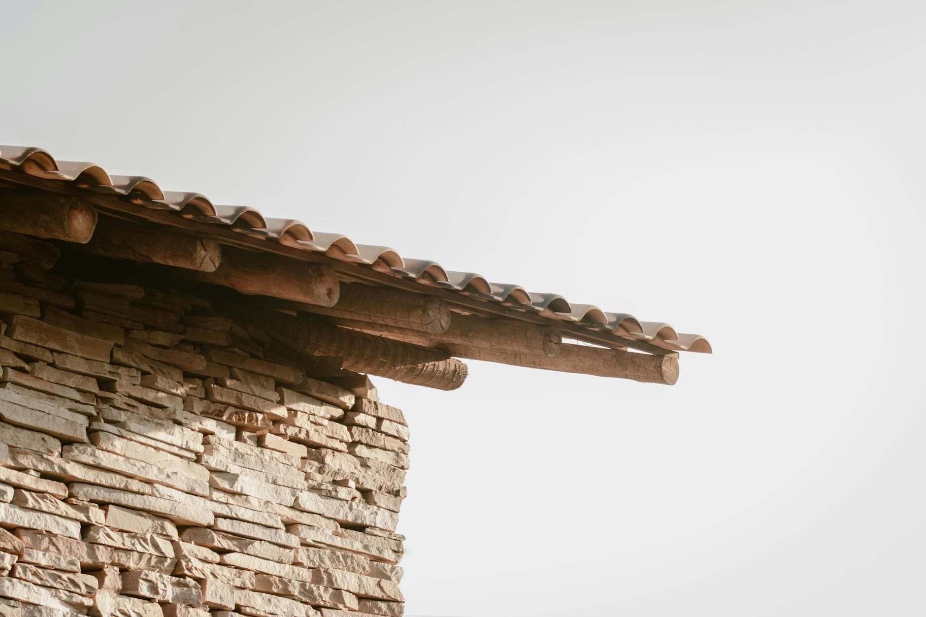 Professional roofer inspecting shingles before storm season
