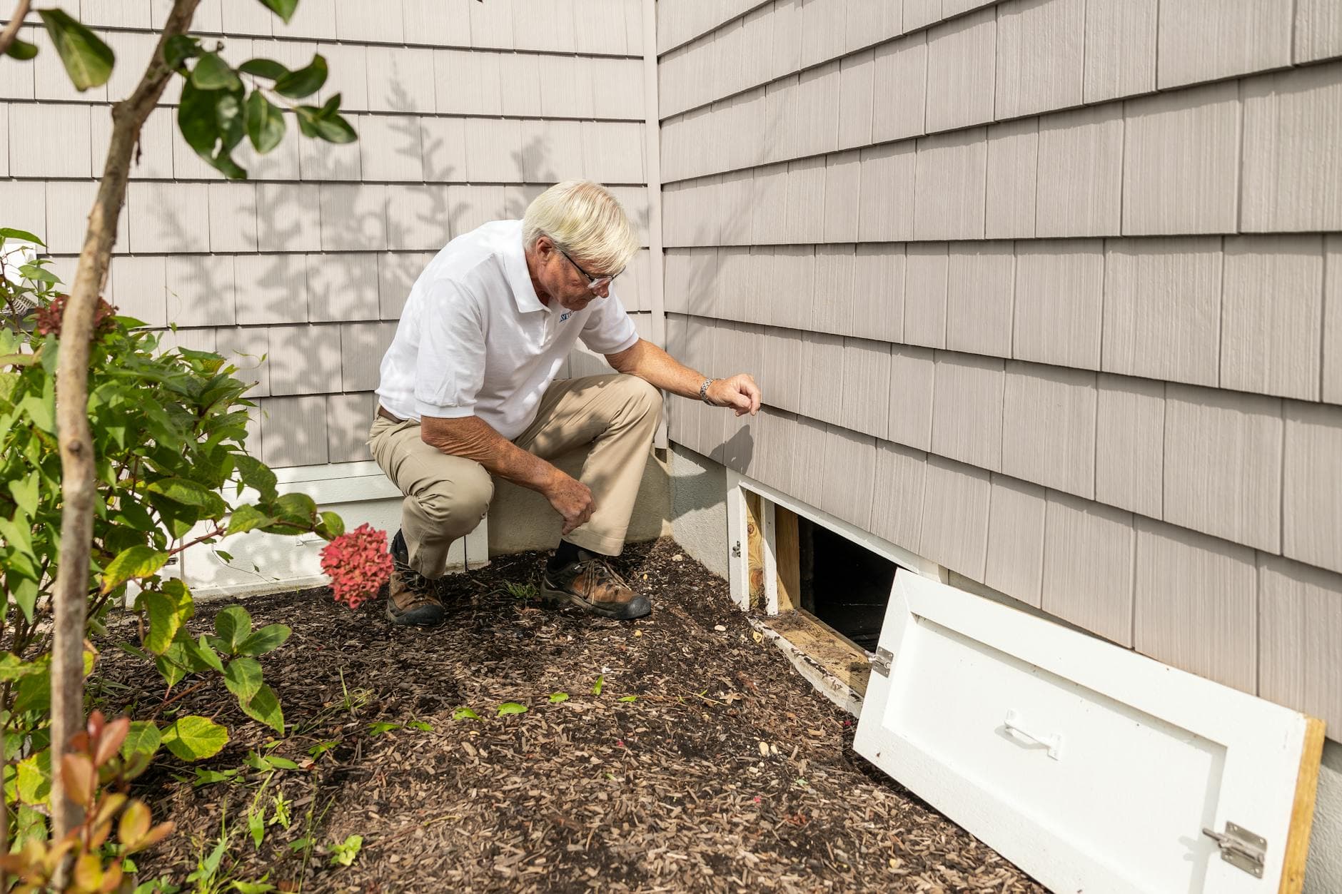 Close-up of roofer checking flashing around a roof vent
