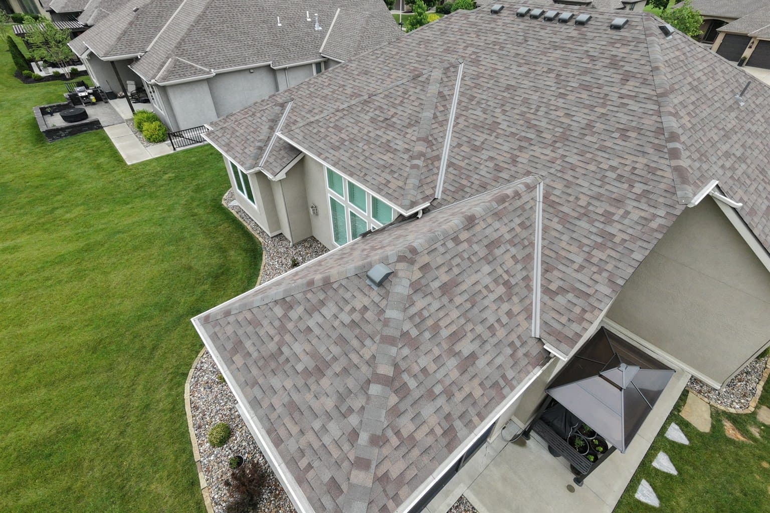 Aerial drone view of a Kansas suburban home during a free roof inspection by MCO Roofing