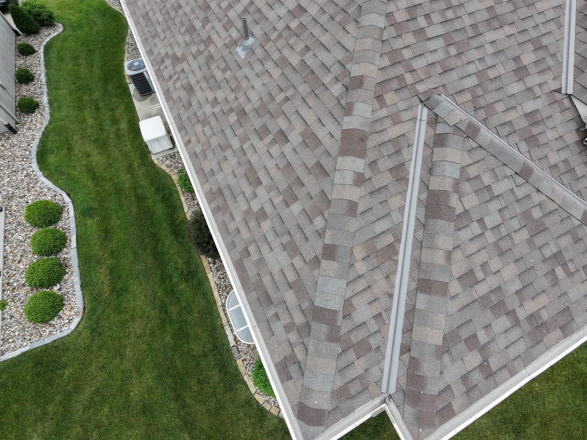 Aerial view of a finished asphalt shingle roof on a Kansas City metro home