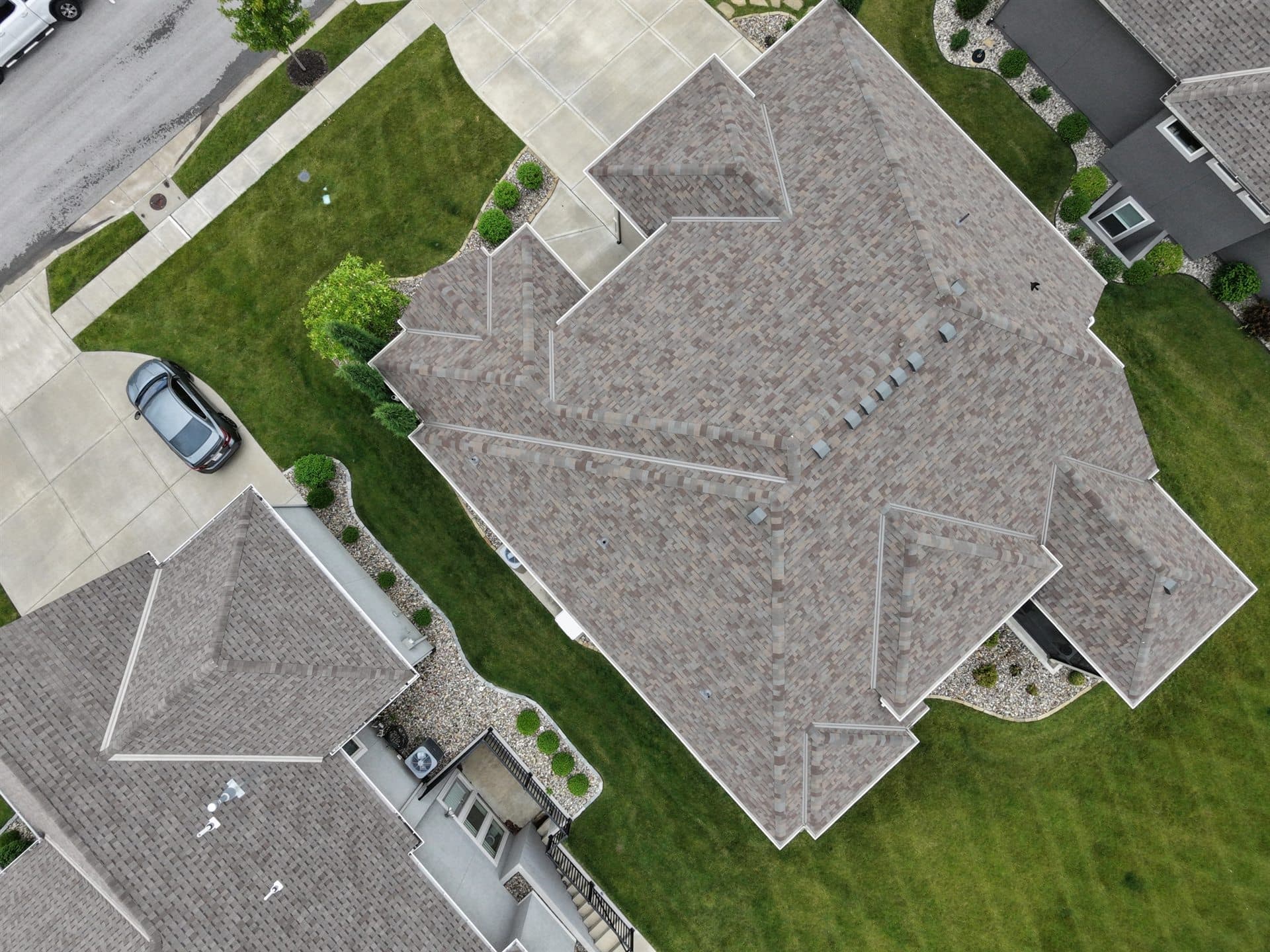 Drone view of a completed roofing project on a suburban Kansas home