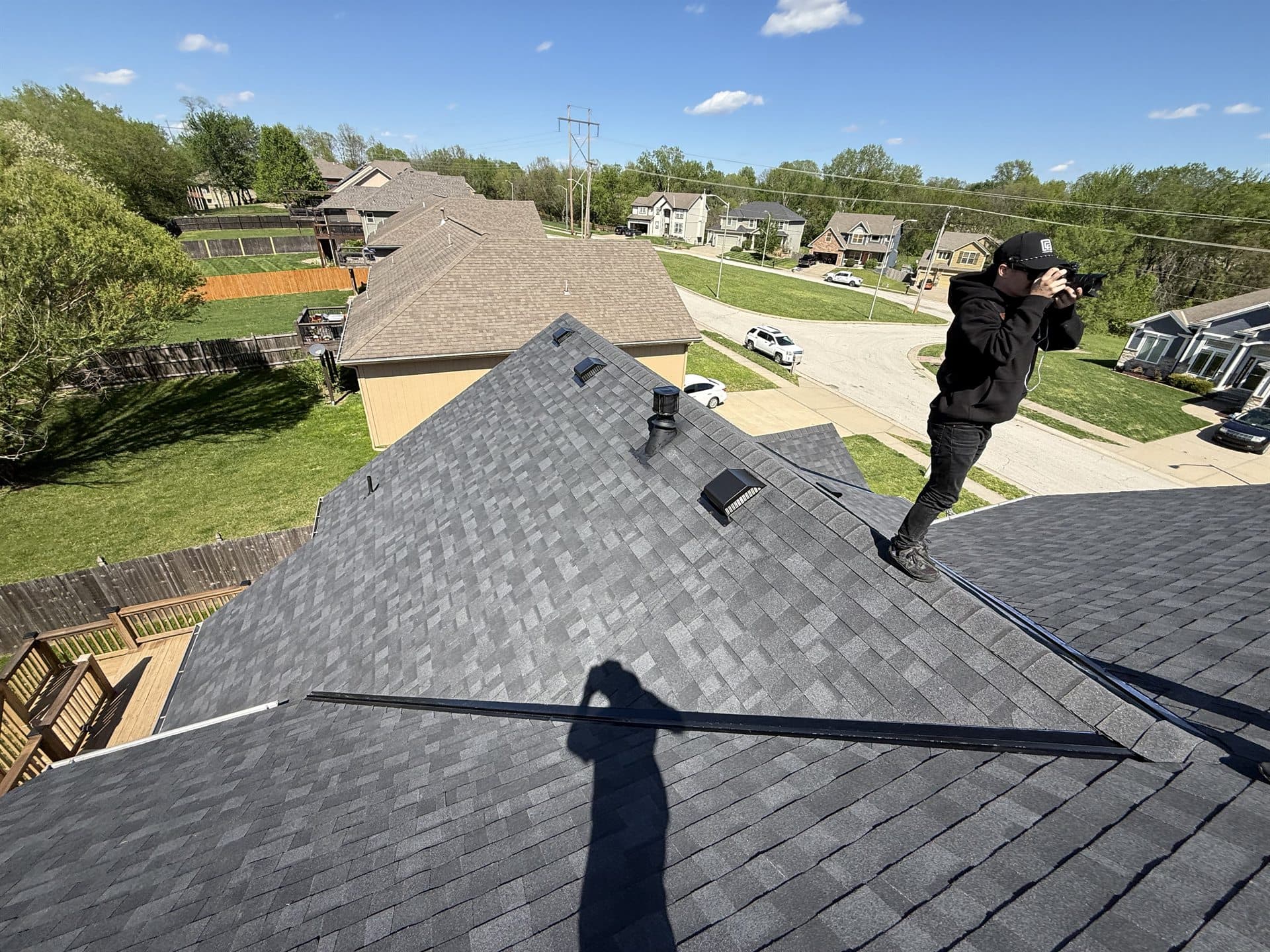 MCO Roofing team member on a freshly completed shingle roof in Kansas