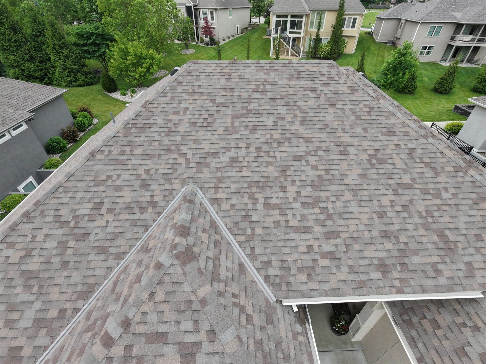 Aerial drone view of a completed shingle roof replacement on a Johnson County, KS home