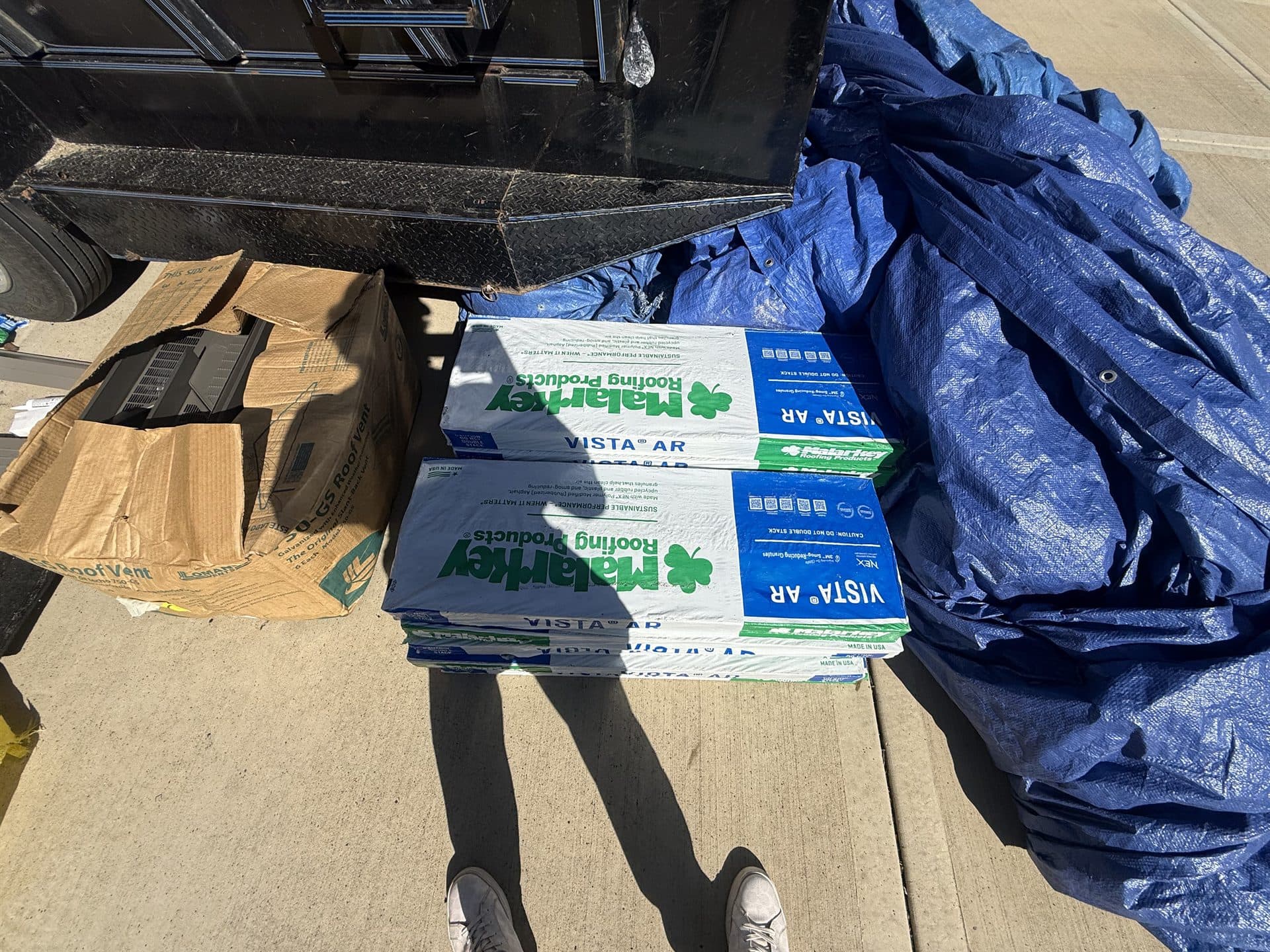 MCO Roofing crew working a roof replacement with materials staged on the roof in Kansas