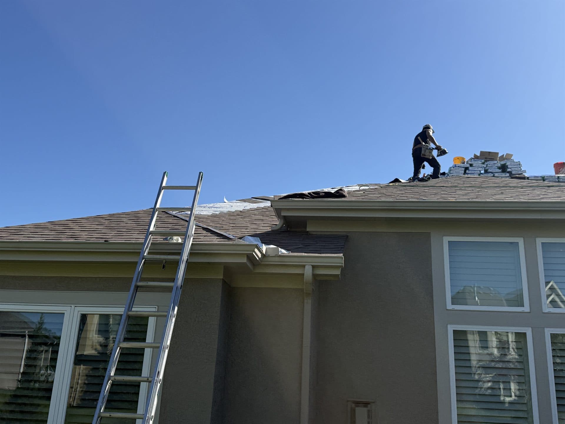 MCO Roofing crew installing a new roof on a large Johnson County, KS home