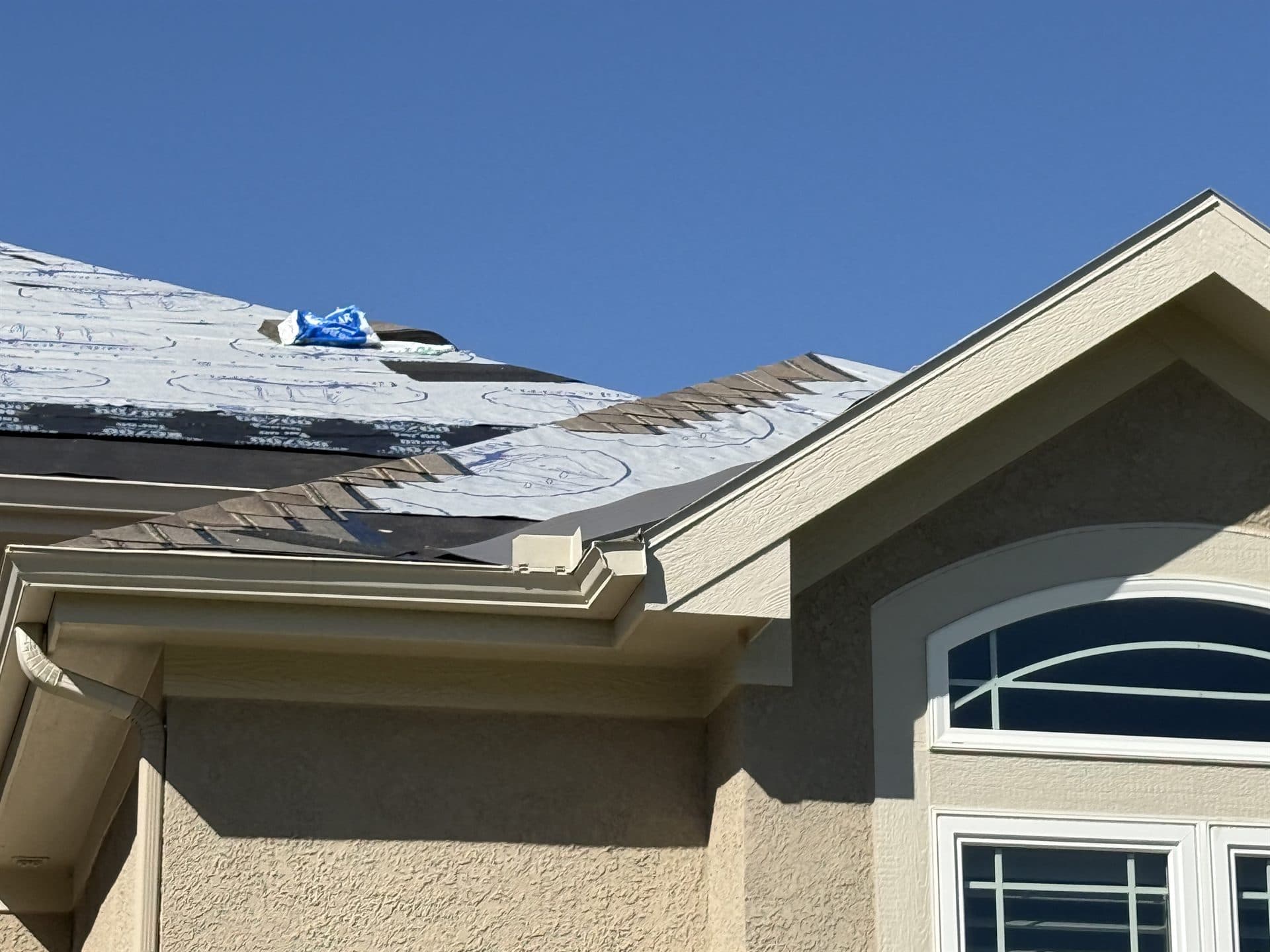 Roof replacement on an arched-window home in the Kansas City metro