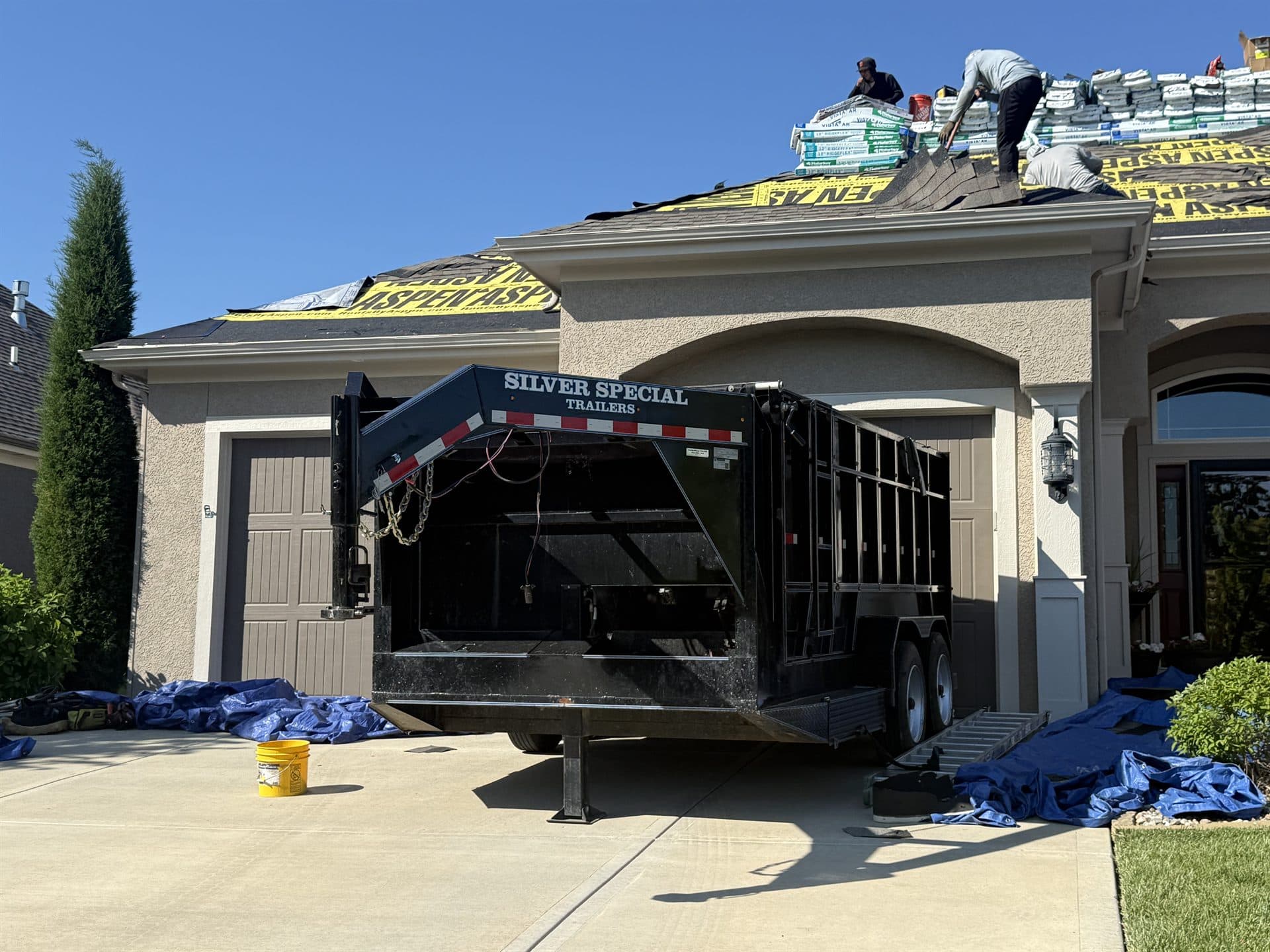 Aerial view of the MCO Roofing crew replacing the roof on a large Kansas home