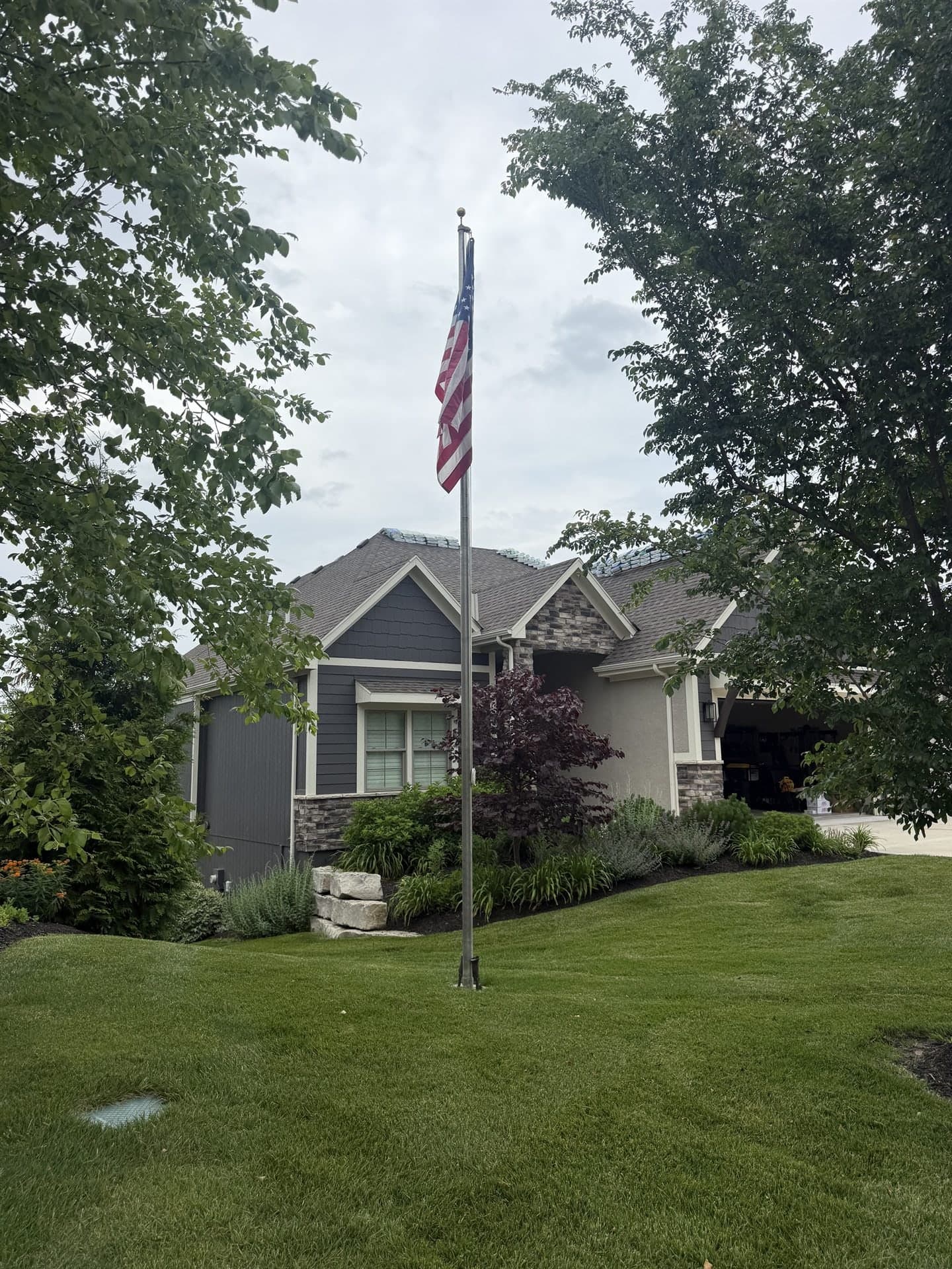 Completed roof on a family home flying an American flag in Kansas