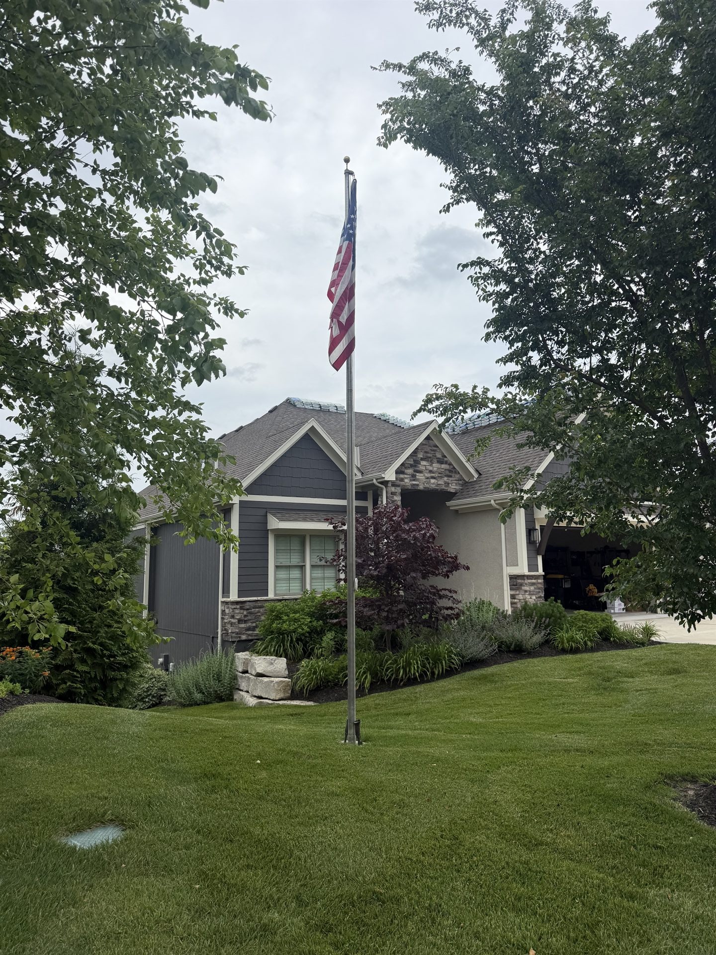 Completed roof on a family home flying an American flag in Kansas