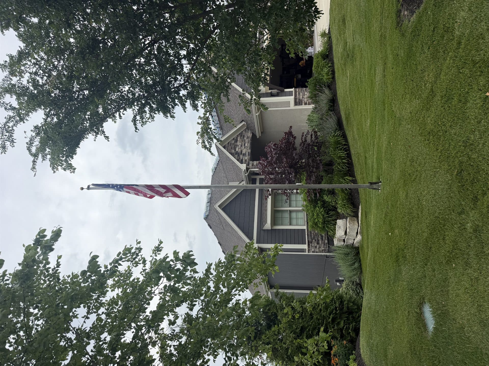 Completed roof on a family home flying an American flag in Kansas