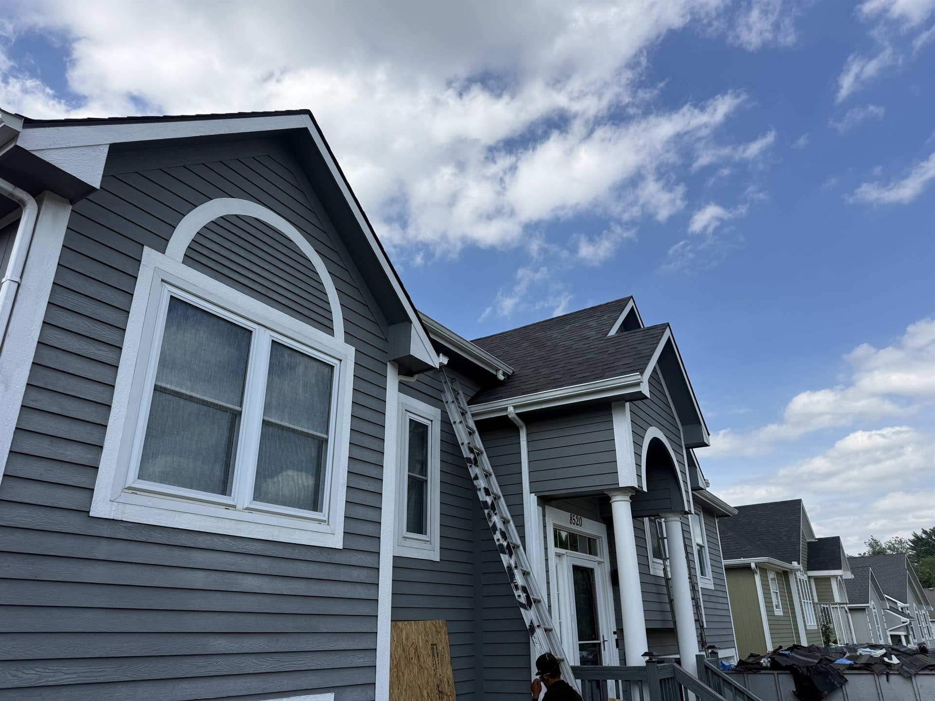 New roof replacement on a blue two-story home in Johnson County, KS