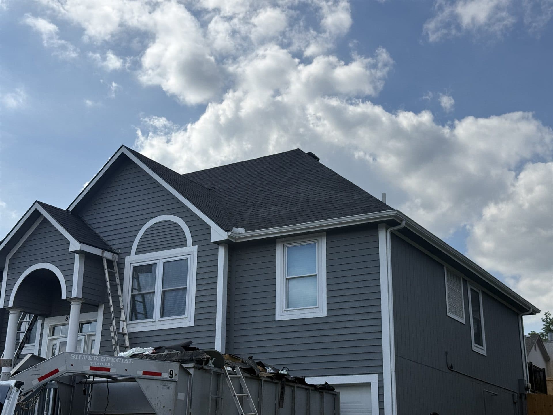 Completed dark architectural shingle roof on a Kansas City metro home