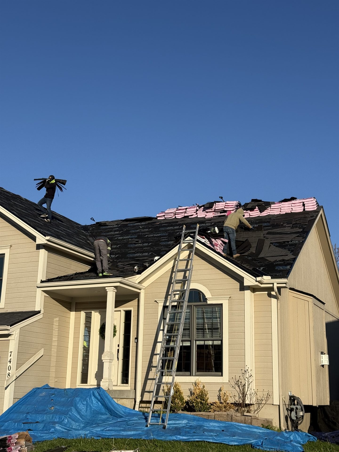 Roof replacement underway on a two-story Johnson County, KS home