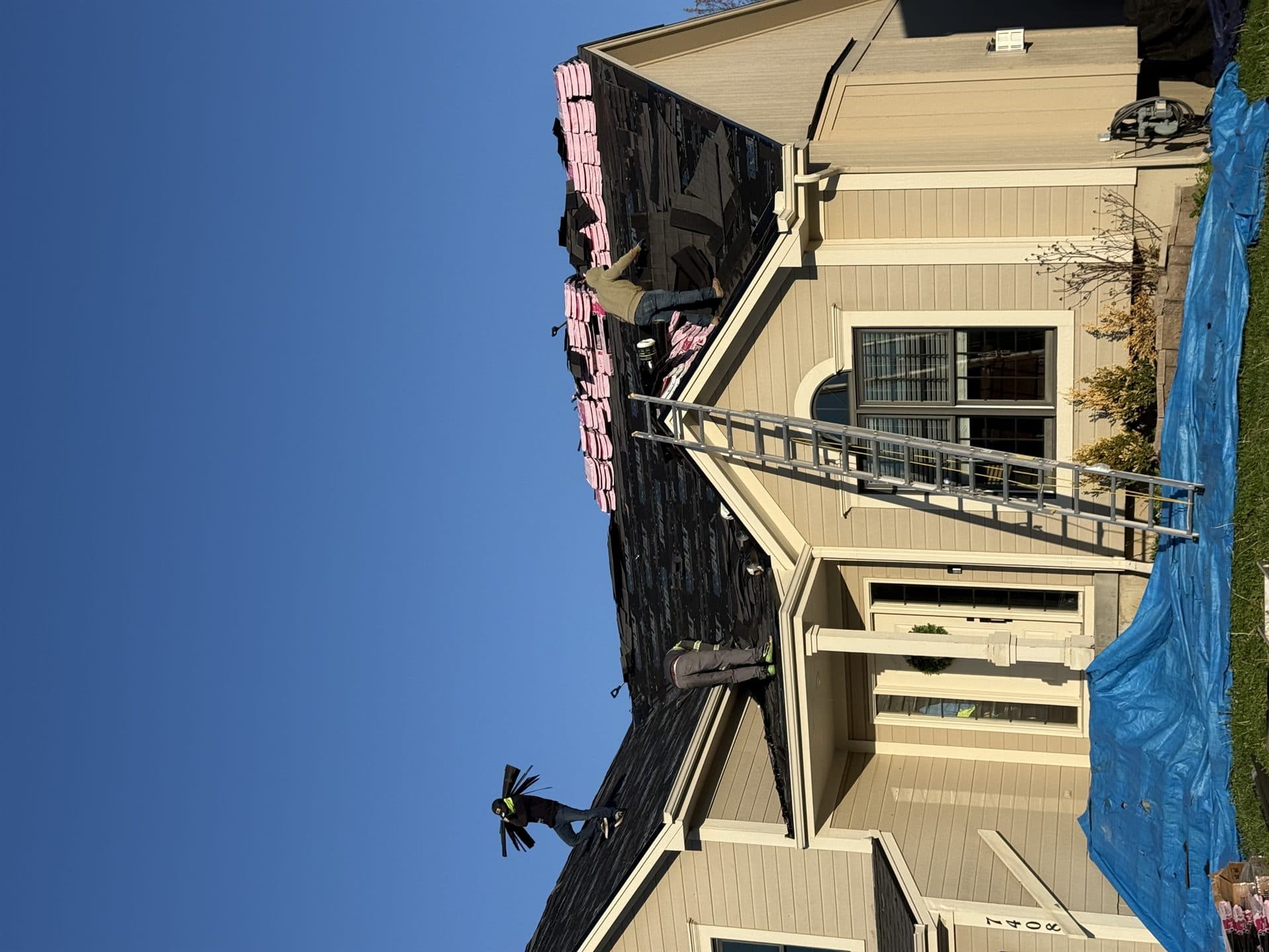 Roof replacement underway on a two-story Johnson County, KS home