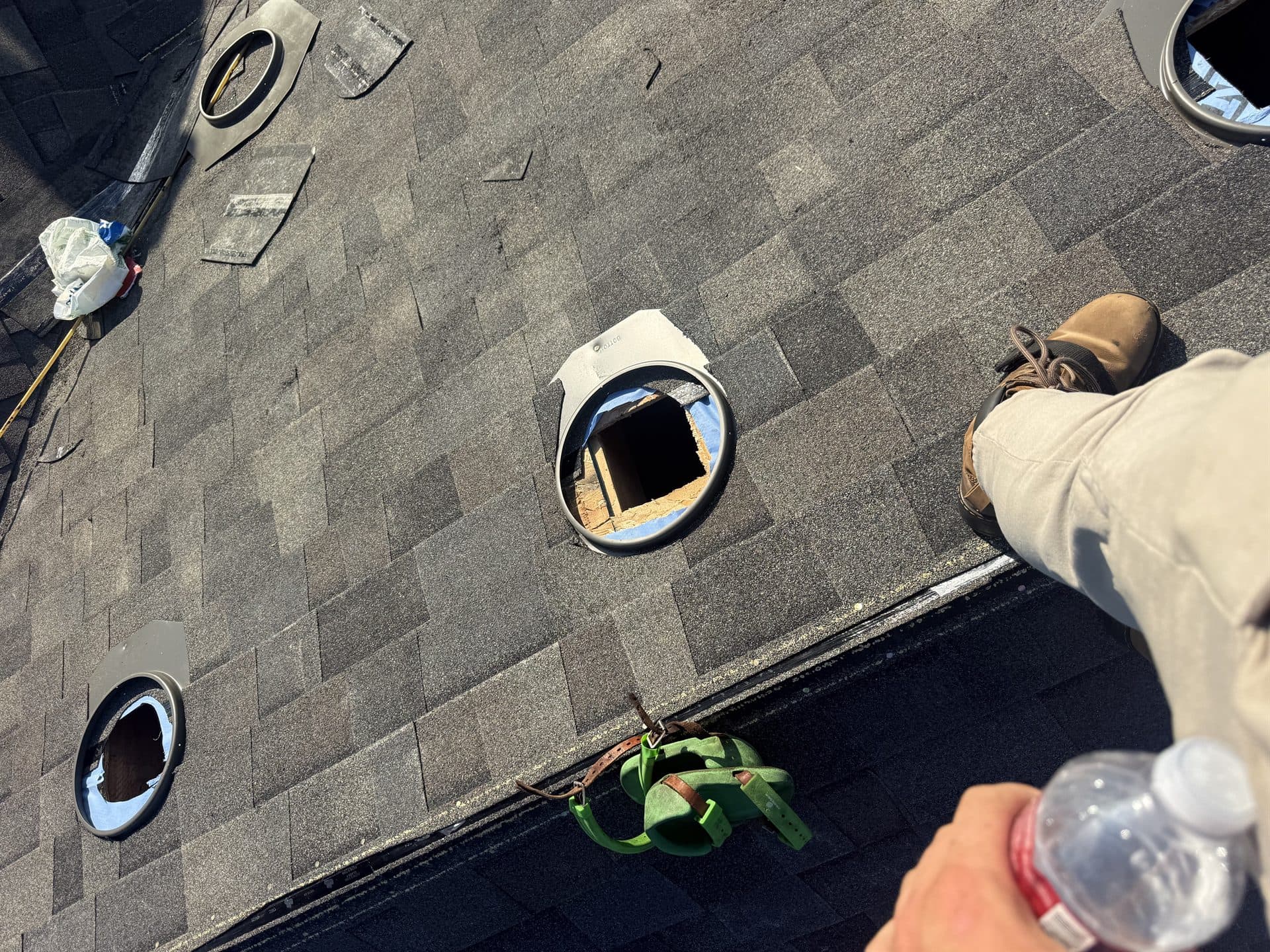 Roofing professional installing a ridge vent on a new shingle roof in Kansas