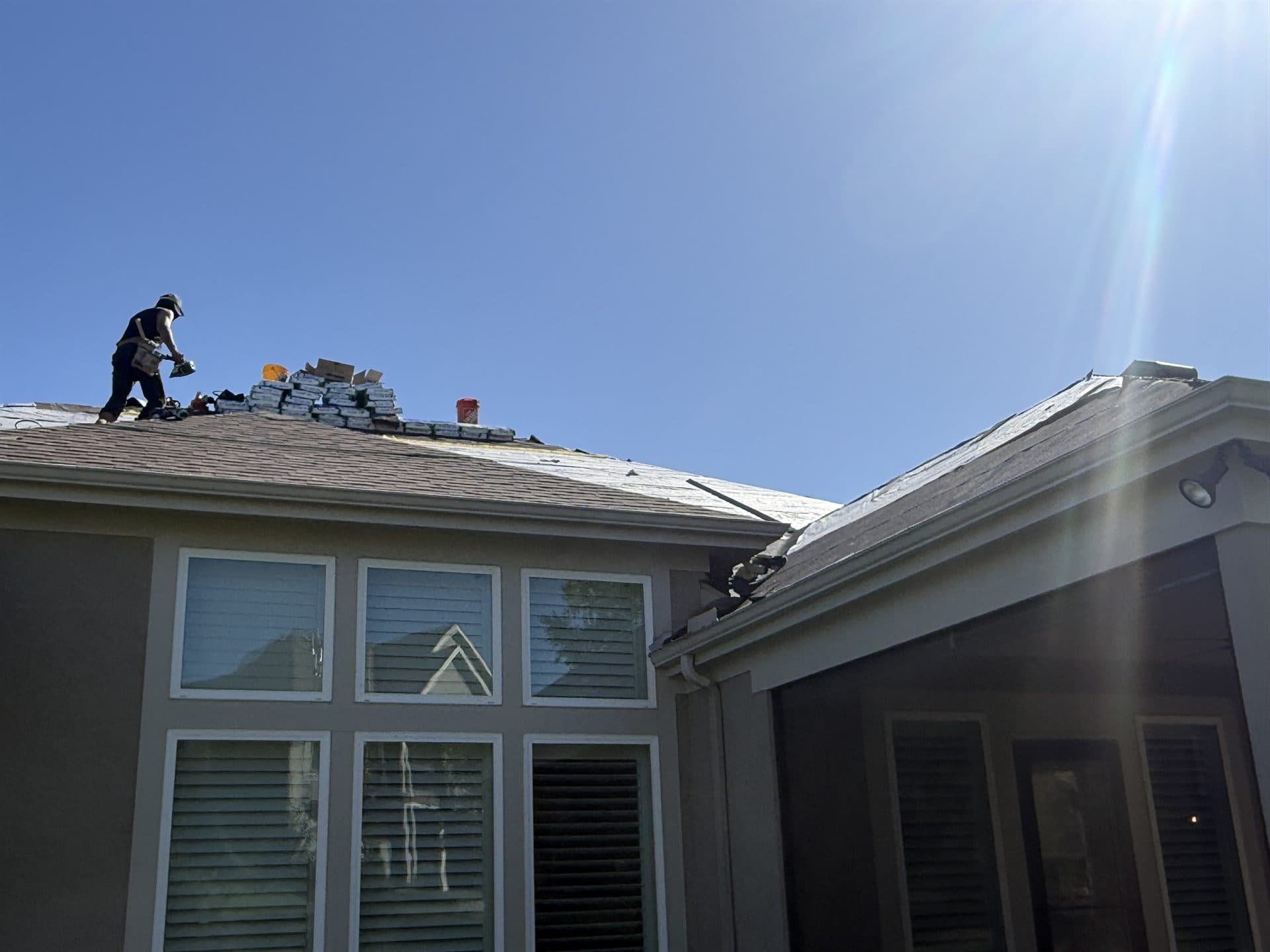 MCO Roofing crew shingling a roof ridge on a Kansas home