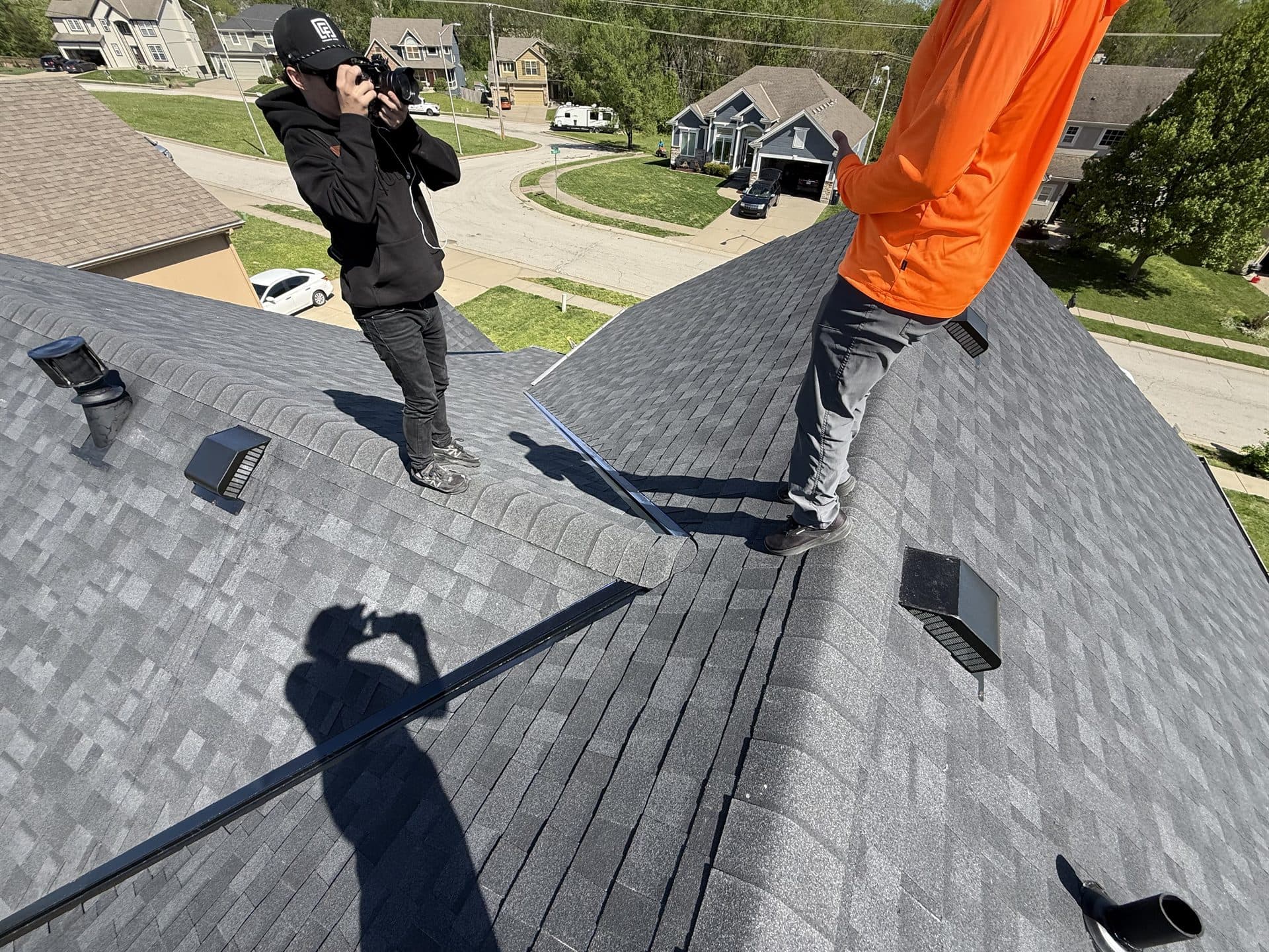 Roofing contractor on a residential roof during an inspection in Kansas