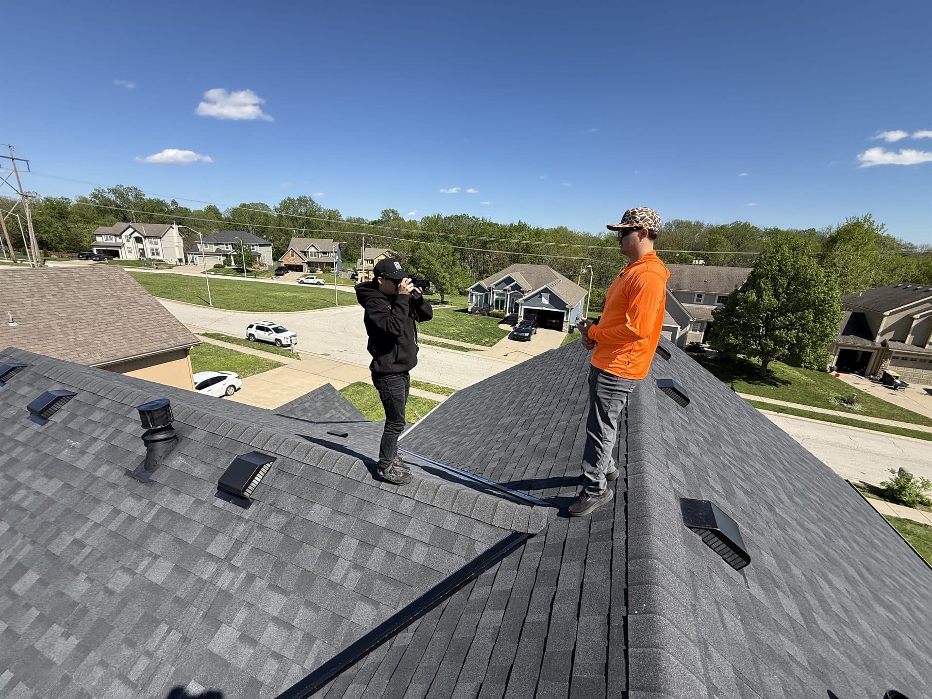 MCO Roofing professional on a completed shingle roof in Johnson County, KS