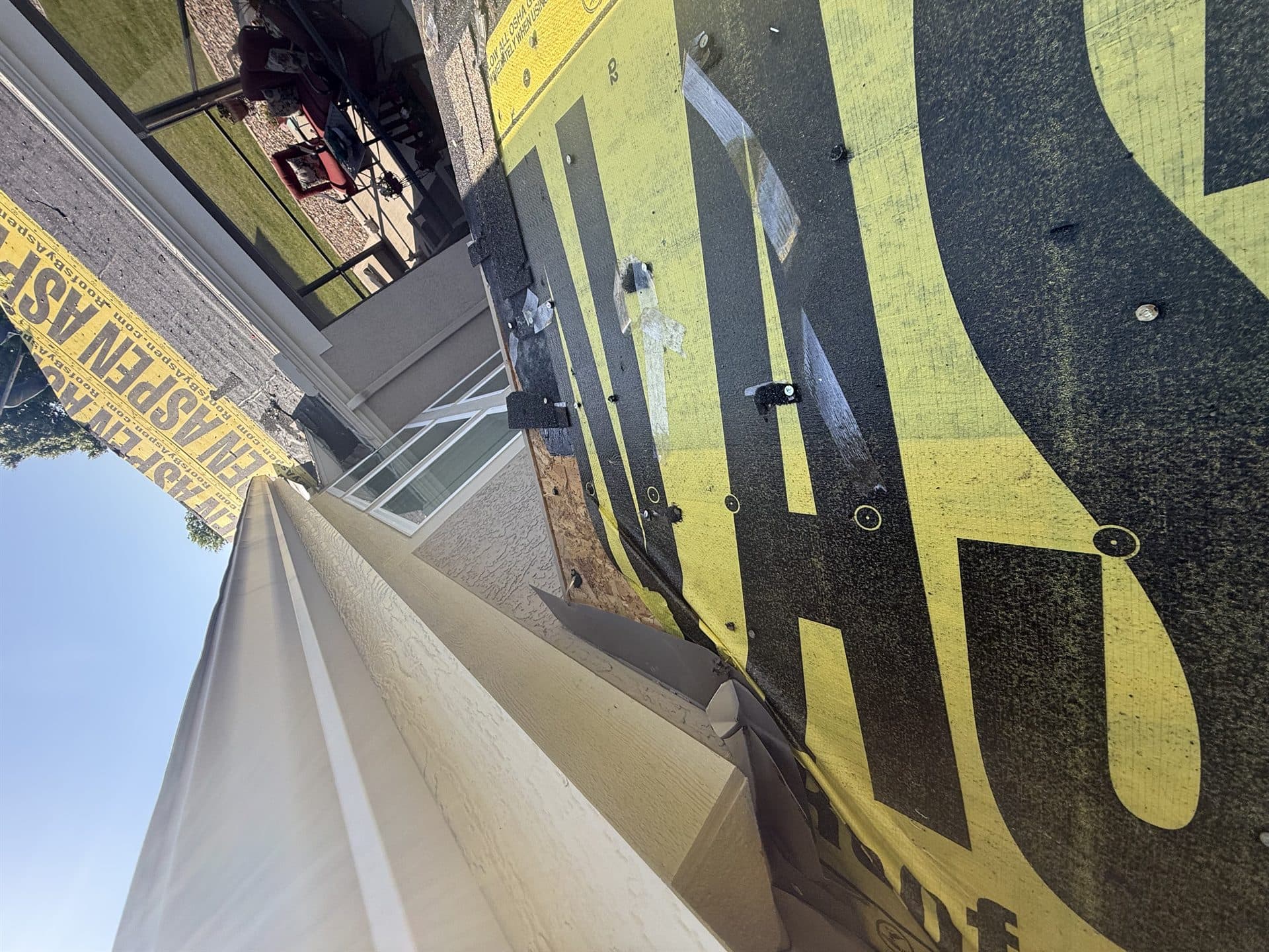 Synthetic roof underlayment rolled out during a roof replacement in Kansas