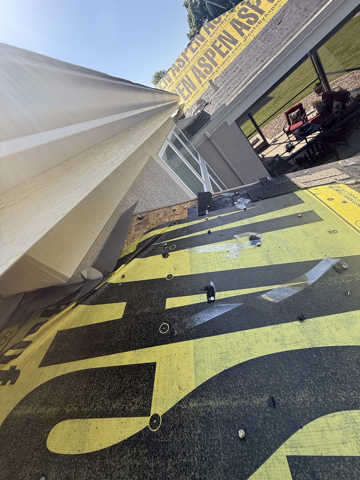Synthetic roof underlayment rolled out during a roof replacement in Kansas