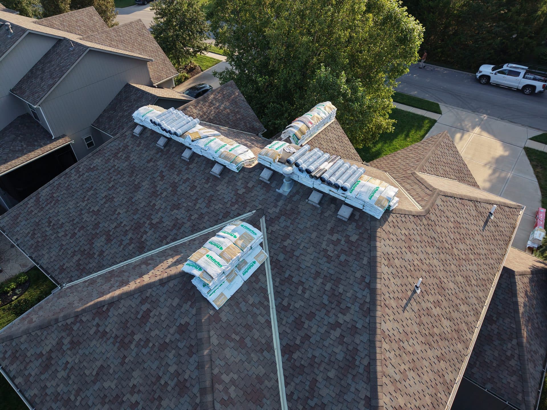 Drone photo of a roof replacement staged for tear-off in an Olathe, KS neighborhood