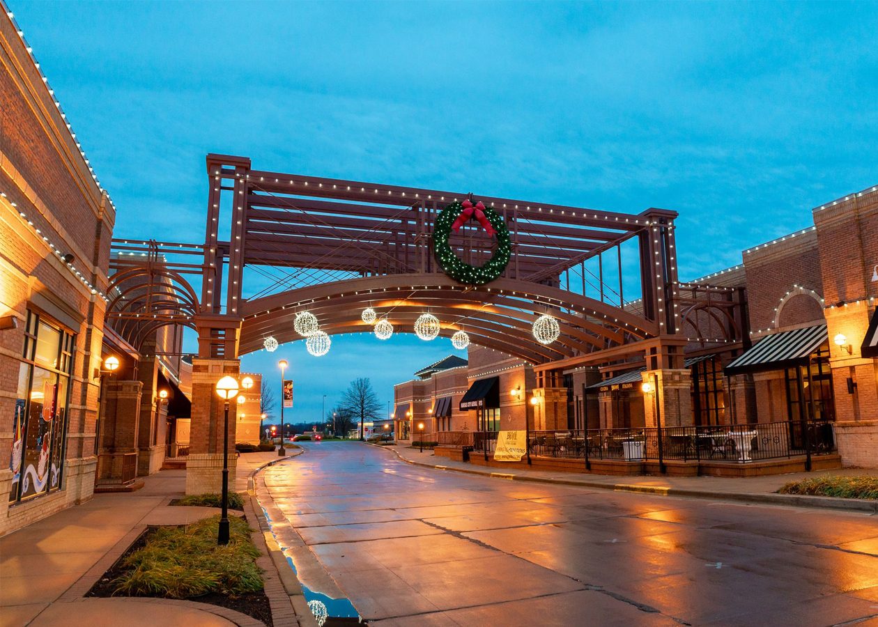 Holiday lights and a wreath on a street arch in a Leawood shopping district
