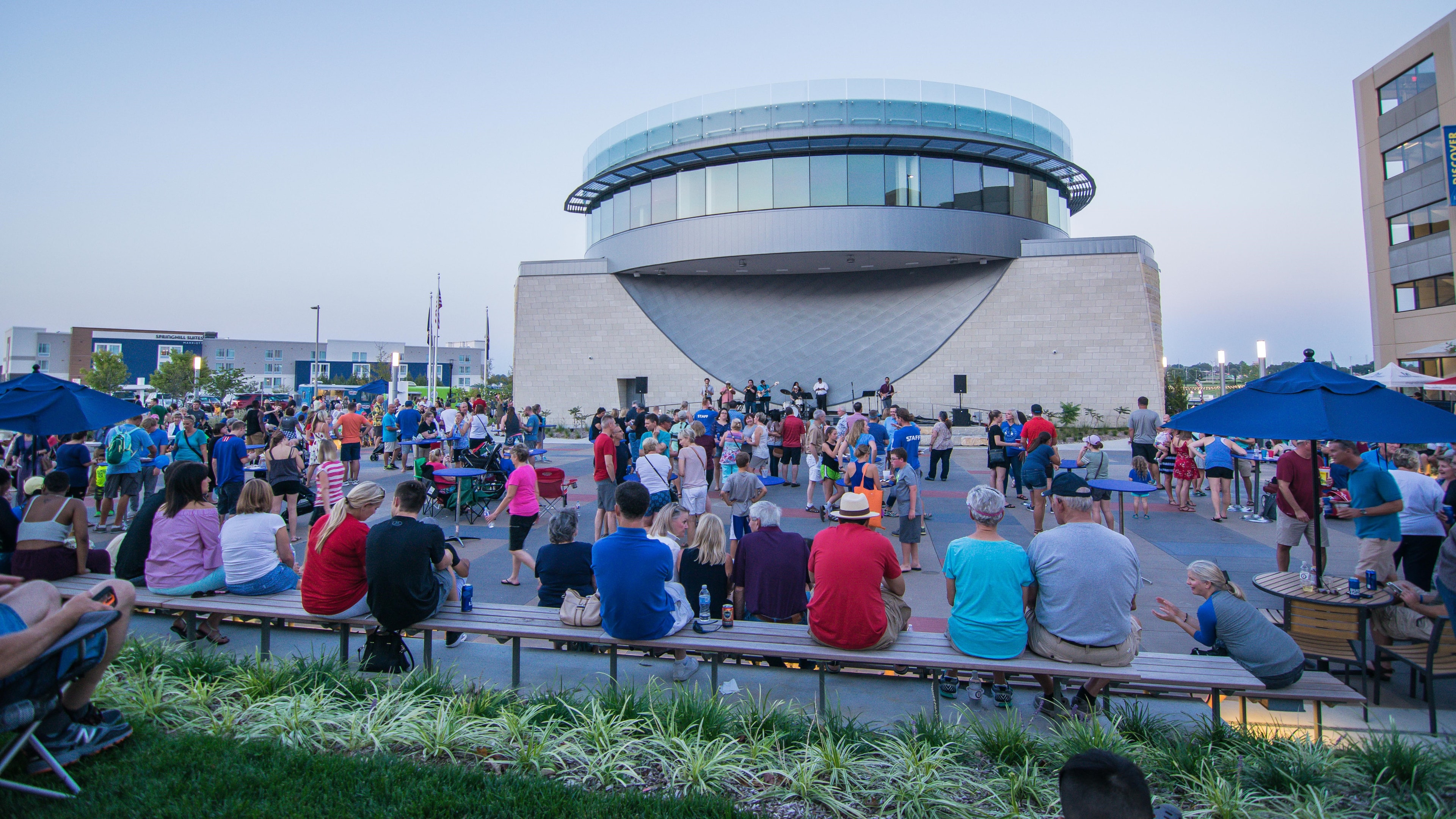A crowd gathered for an evening event on the civic plaza at Lenexa City Center
