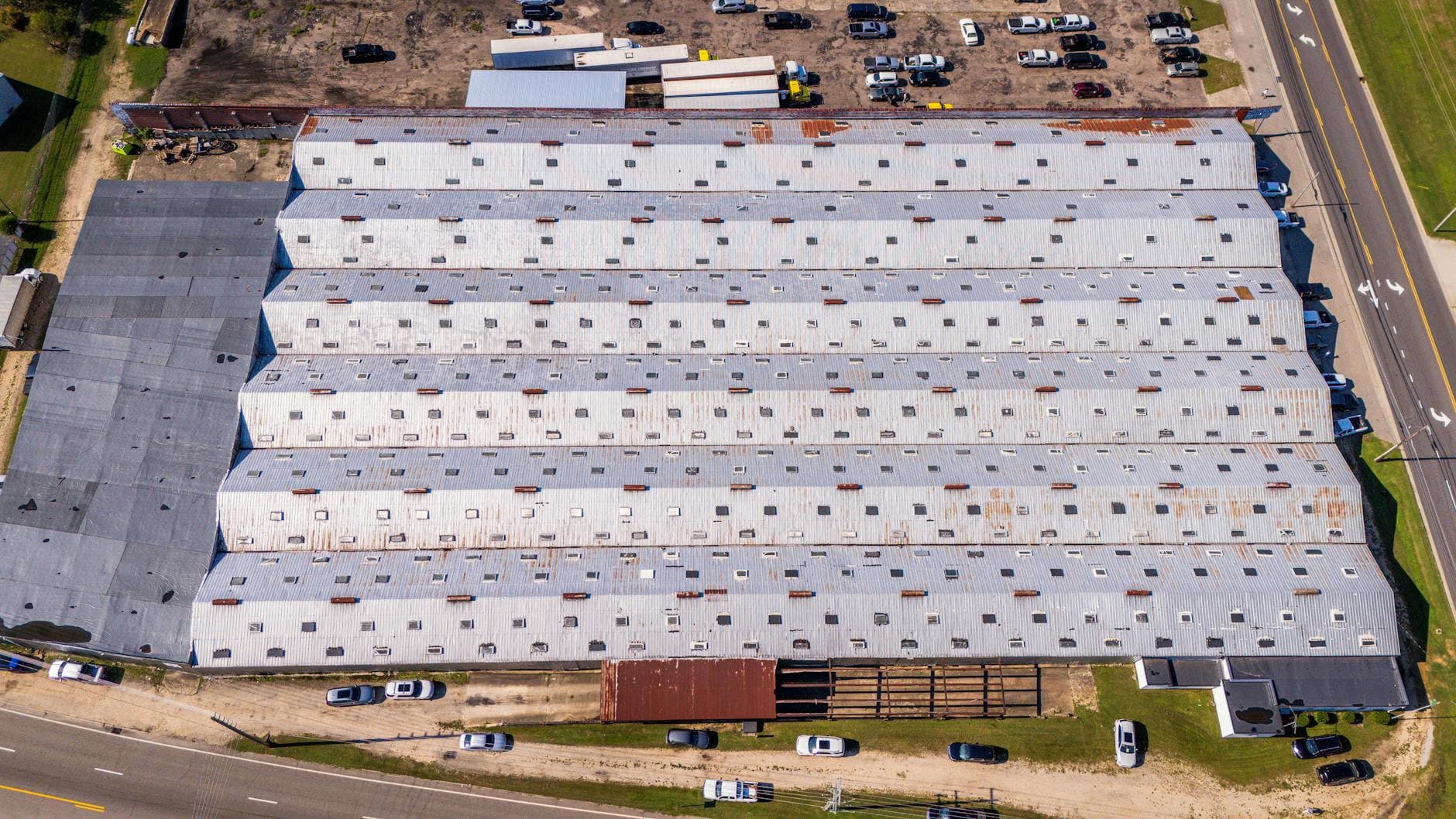 Low-slope commercial roof with a white membrane and rooftop units, typical of the flat roofing MCO Roofing services in Johnson County