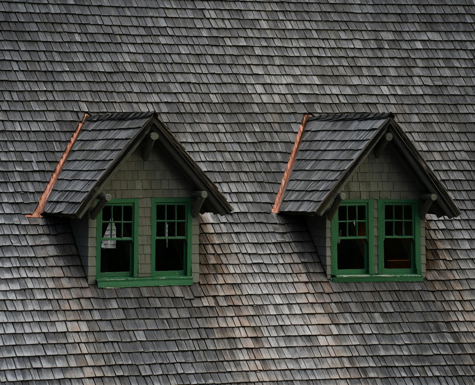 Cedar shake roof with twin dormers on an older Lenexa, Kansas home
