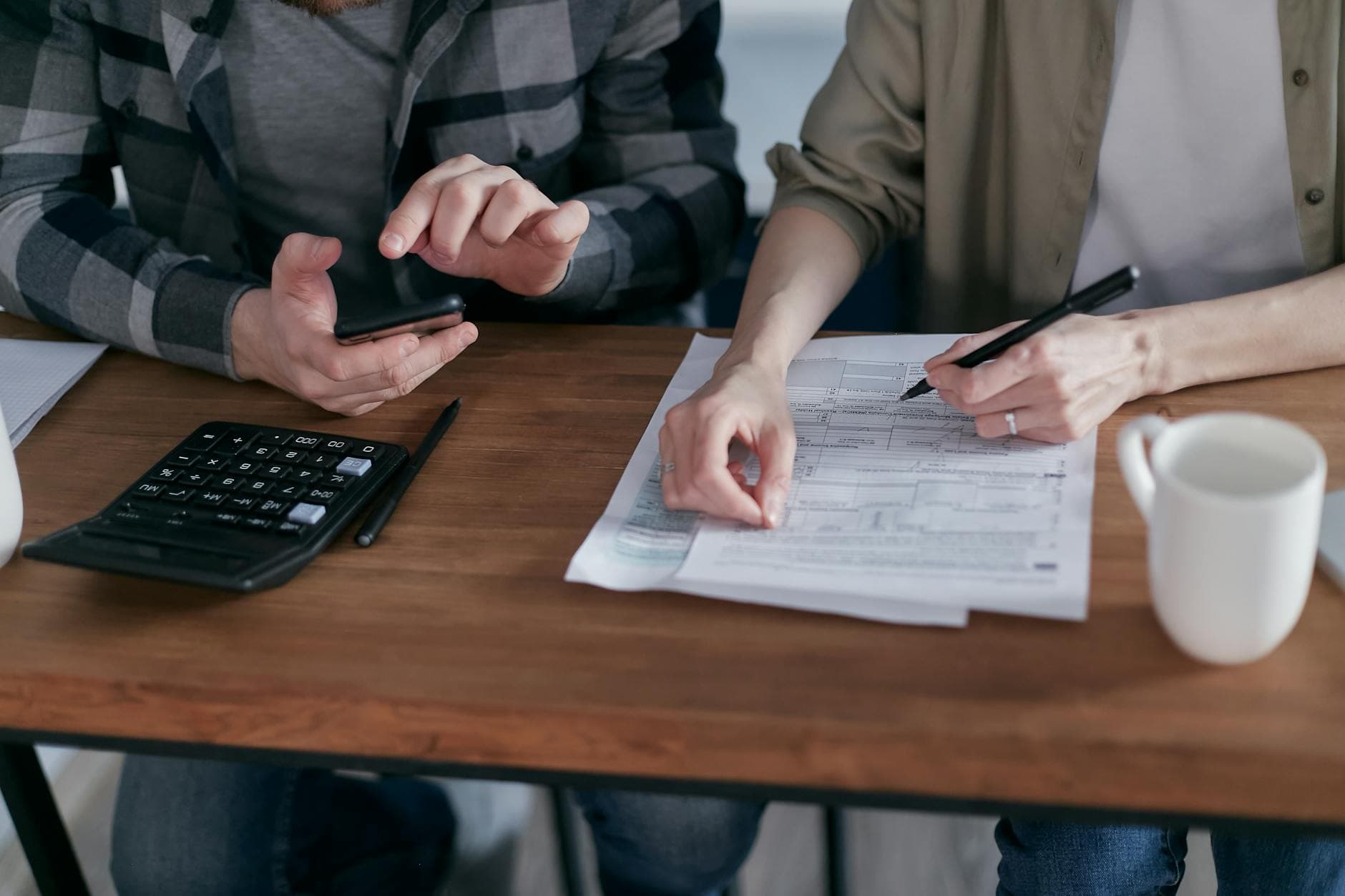 Homeowner reviewing insurance paperwork at kitchen table