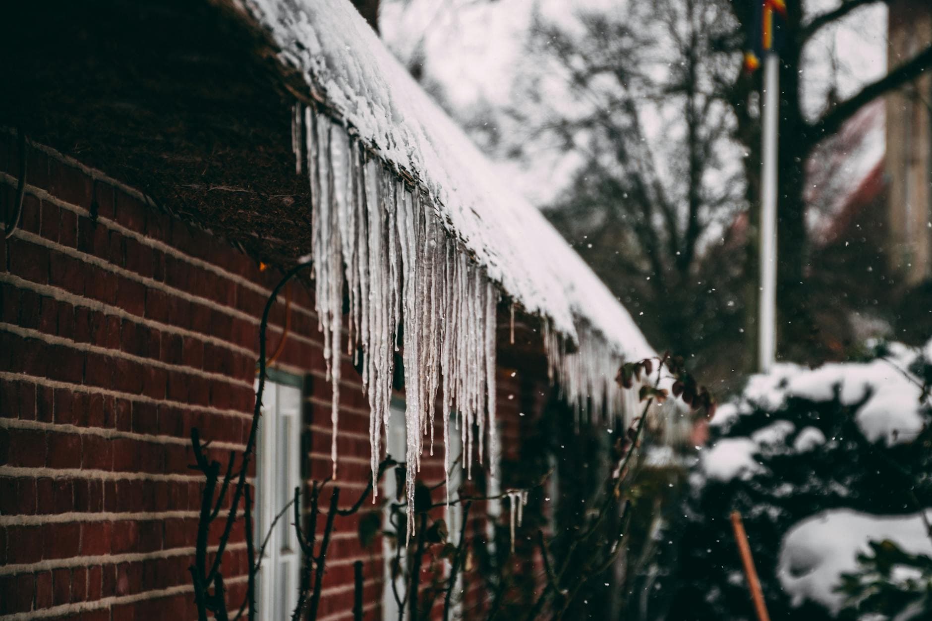 Snow-covered Kansas home with visible roof damage