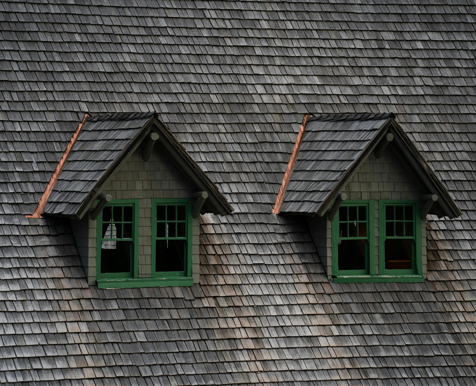 Cedar shake roof with twin dormers on an older Lenexa, Kansas home