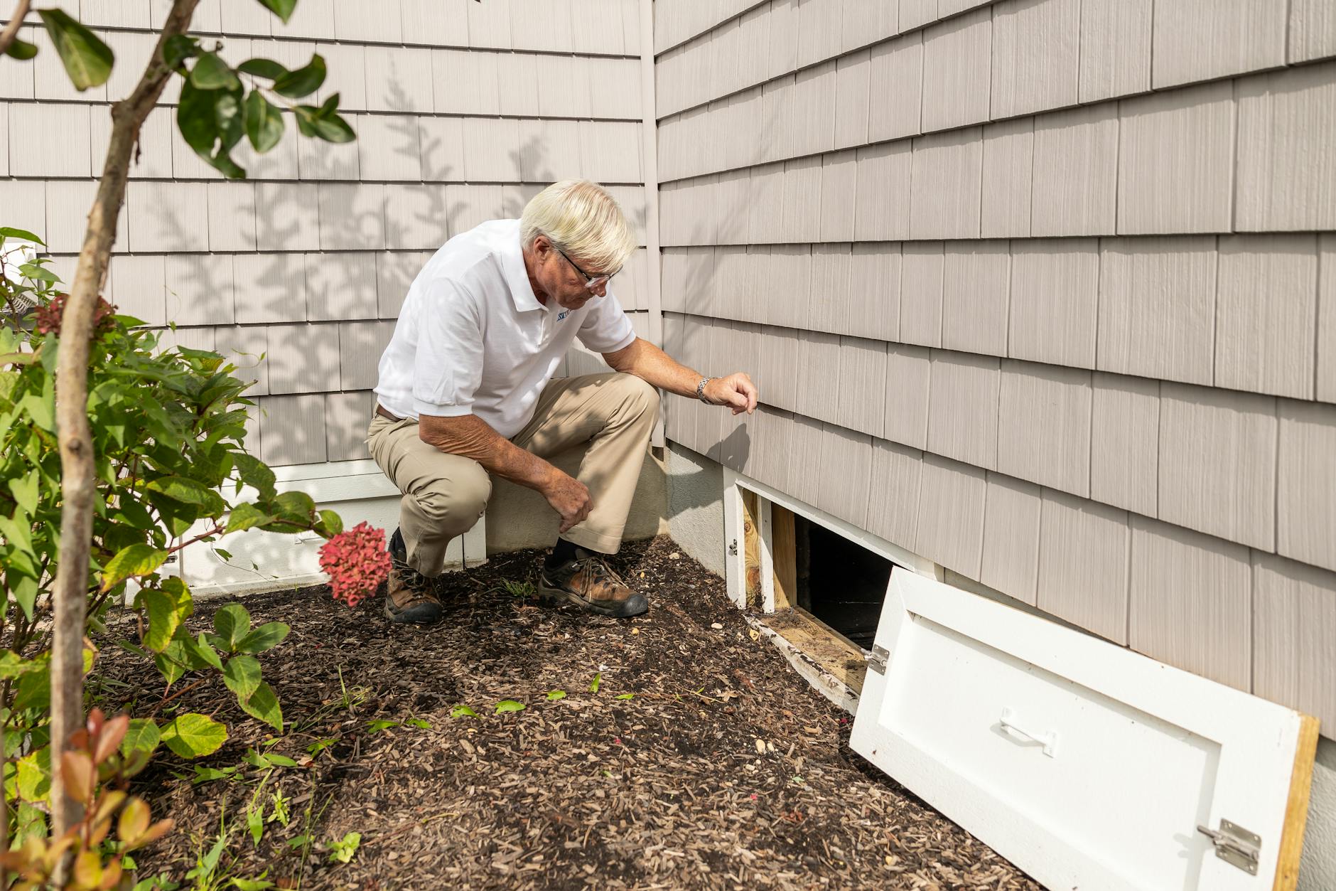 Close-up of roofer checking flashing around a roof vent